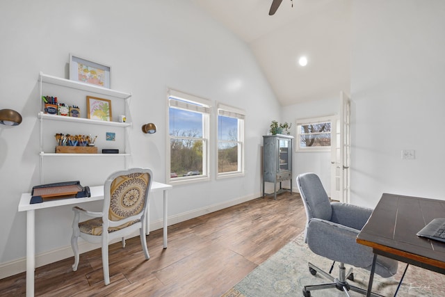 office featuring wood finished floors, ceiling fan, high vaulted ceiling, and baseboards