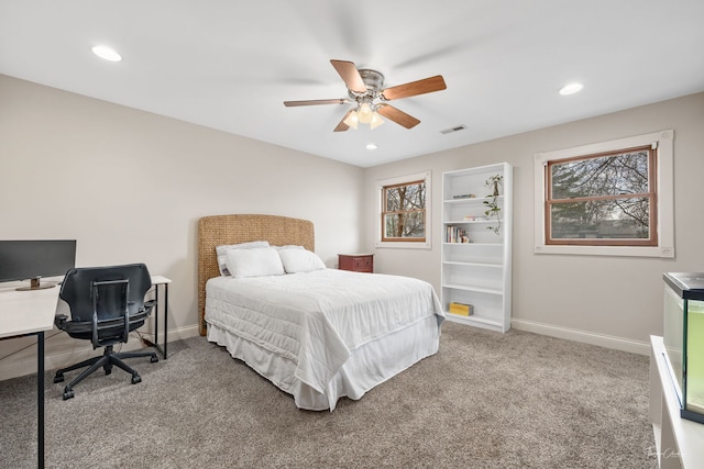 carpeted bedroom featuring baseboards, visible vents, and multiple windows