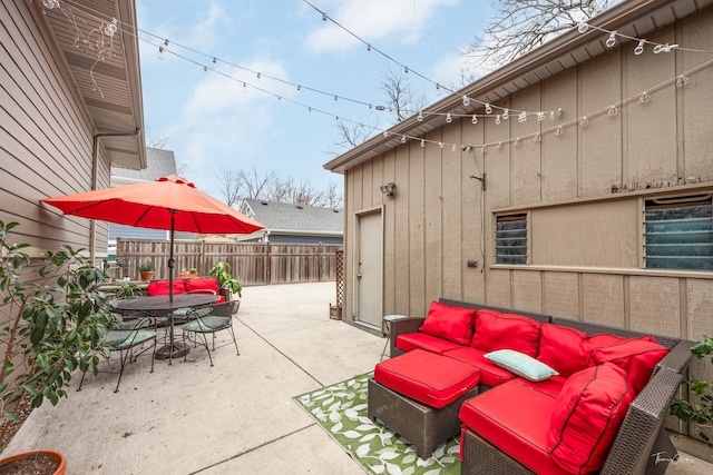 view of patio / terrace featuring fence, outdoor dining space, and outdoor lounge area