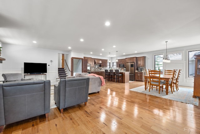 living area featuring light wood finished floors and recessed lighting
