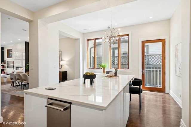 kitchen featuring a wealth of natural light, a notable chandelier, and dark wood-style flooring