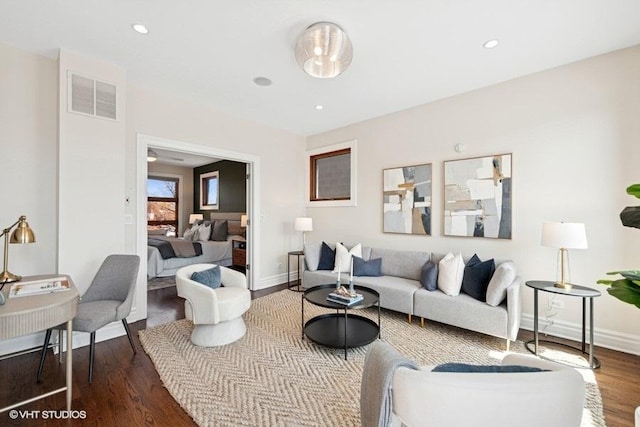 living room with recessed lighting, wood finished floors, visible vents, and baseboards