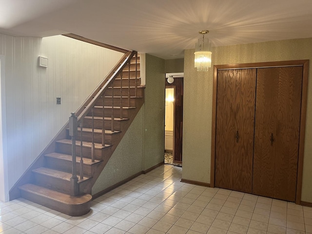9609 S Kenneth Ave, Oak Lawn, IL 60453 - stairs featuring tile patterned floors, a chandelier, and baseboards