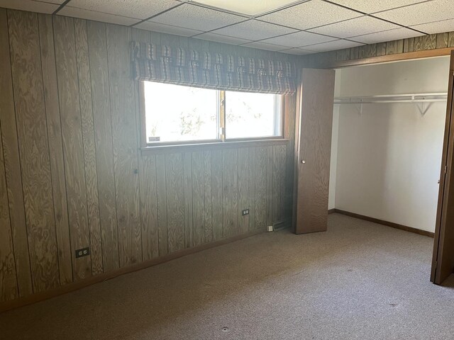 9609 S Kenneth Ave, Oak Lawn, IL 60453 - unfurnished bedroom with baseboards, wood walls, carpet, and a closet
