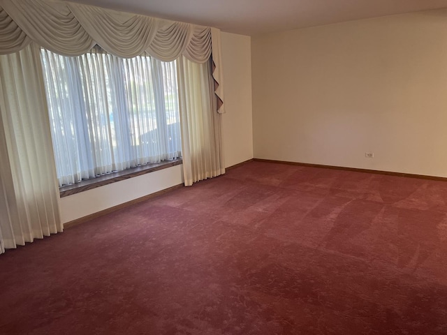 9609 S Kenneth Ave, Oak Lawn, IL 60453 - empty room with baseboards and dark colored carpet