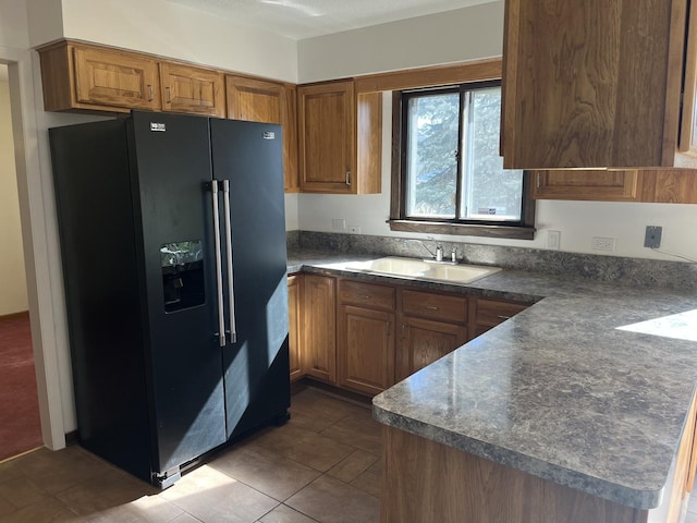 9609 S Kenneth Ave, Oak Lawn, IL 60453 - kitchen featuring dark tile patterned floors, dark countertops, black fridge with ice dispenser, brown cabinets, and a sink
