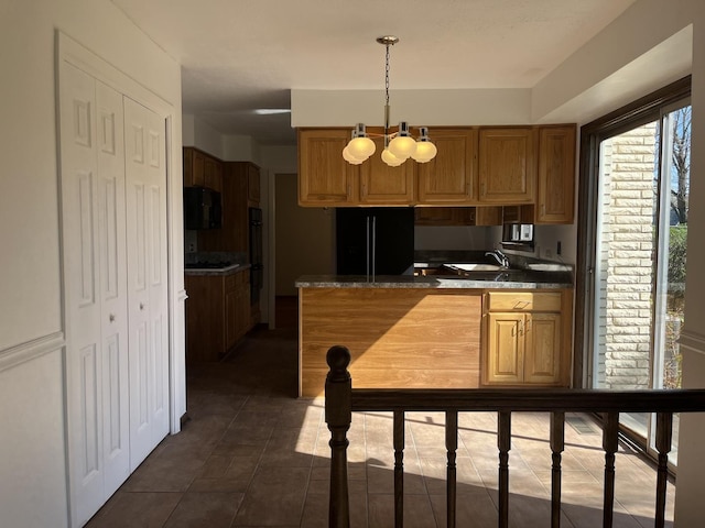 9609 S Kenneth Ave, Oak Lawn, IL 60453 - kitchen featuring dark countertops, hanging light fixtures, brown cabinets, dark tile patterned flooring, and black appliances