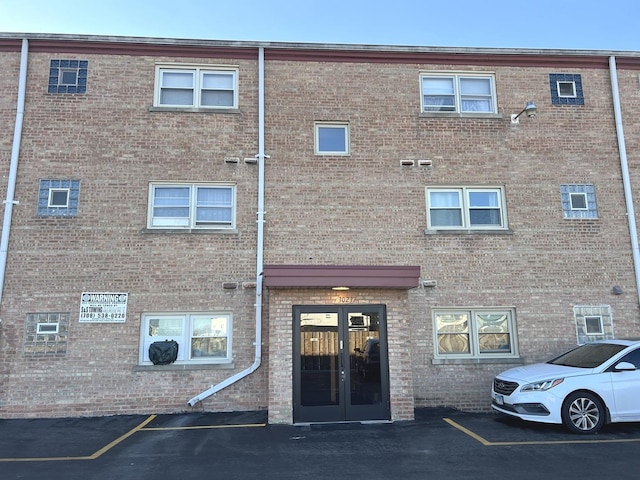 view of building exterior with uncovered parking