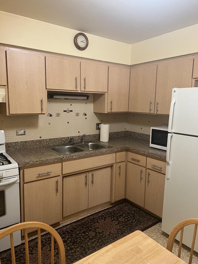 kitchen featuring white appliances, a sink, exhaust hood, light brown cabinets, and backsplash