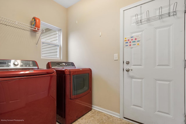 washroom featuring separate washer and dryer, baseboards, tile patterned flooring, and laundry area