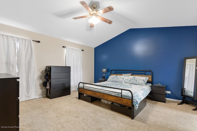 bedroom with baseboards, lofted ceiling, ceiling fan, and carpet
