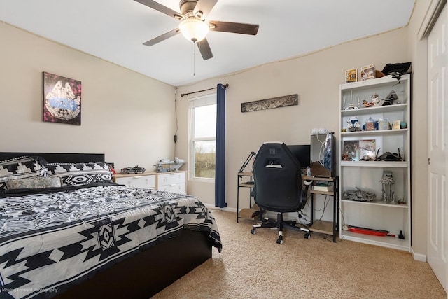 bedroom featuring ceiling fan, a closet, baseboards, and light carpet