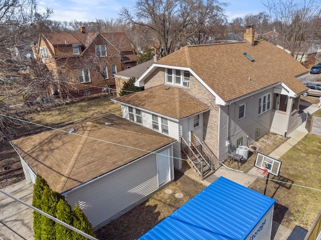 rear view of property featuring a residential view, central air condition unit, a chimney, fence, and a shingled roof