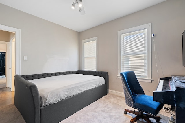 carpeted bedroom featuring baseboards