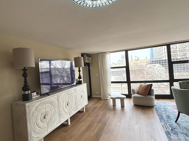 2605 S Indiana Ave Unit 305, Chicago, IL 60616 - sitting room with an AC wall unit, baseboards, wood finished floors, and floor to ceiling windows