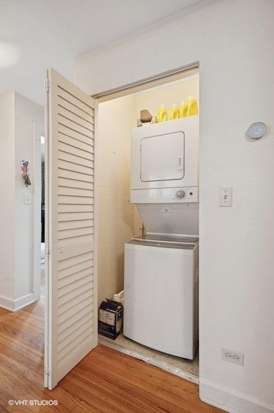 3128 W Carmen Ave Unit 2, Chicago, IL 60625 - washroom with stacked washer / dryer, wood finished floors, and baseboards