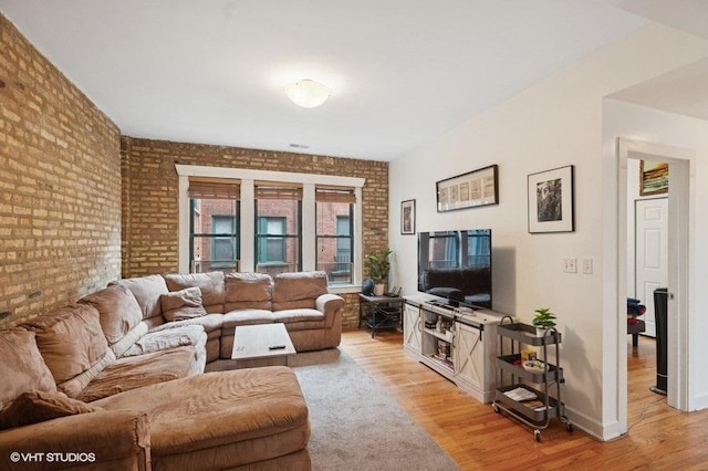 3128 W Carmen Ave Unit 2, Chicago, IL 60625 - living area featuring light wood finished floors, brick wall, and baseboards