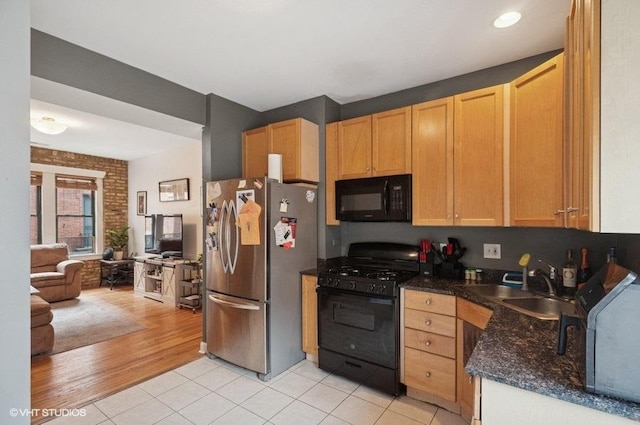 3128 W Carmen Ave Unit 2, Chicago, IL 60625 - kitchen with black appliances, a sink, light tile patterned floors, open floor plan, and dark stone counters