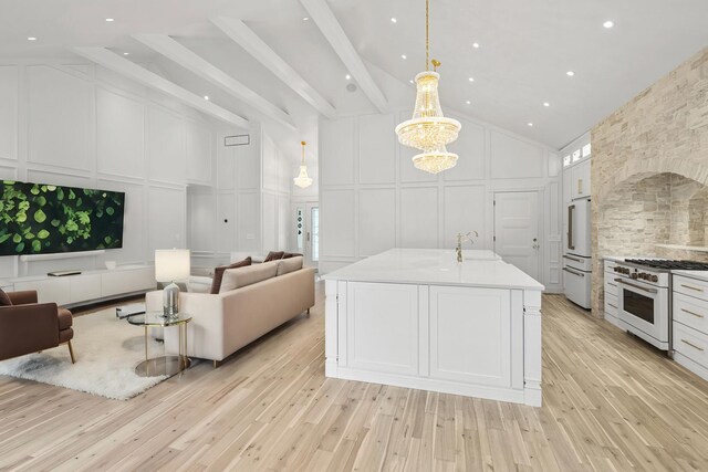 1004 Golden Ave, Woodstock, IL 60098 - kitchen featuring white range with gas cooktop, open floor plan, high vaulted ceiling, and a decorative wall
