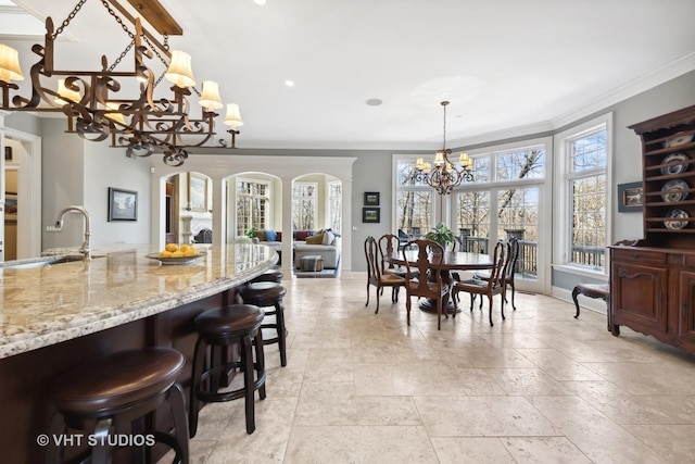 dining area featuring baseboards, a wealth of natural light, and a notable chandelier