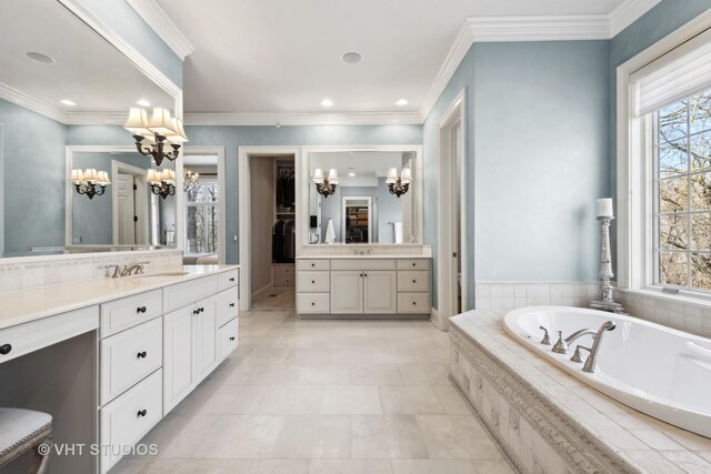 bathroom with a garden tub, a chandelier, and a healthy amount of sunlight