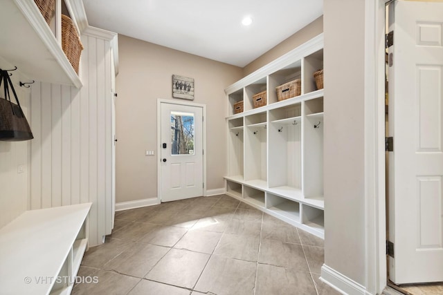 mudroom with baseboards and light tile patterned floors