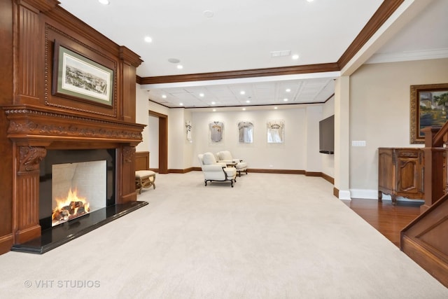 unfurnished room with baseboards, a warm lit fireplace, recessed lighting, and ornamental molding