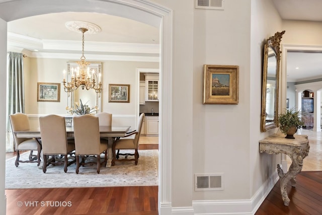 dining area with arched walkways, visible vents, and dark wood-style flooring