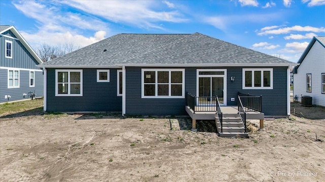 back of house featuring central air condition unit, a wooden deck, and a shingled roof