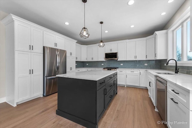 kitchen featuring white cabinets, appliances with stainless steel finishes, and a sink