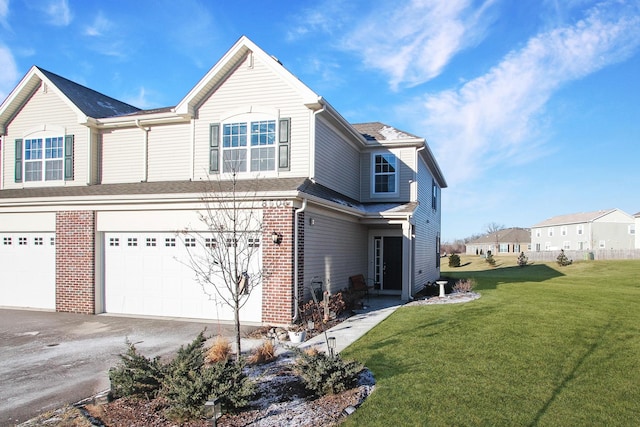 8506 Stillwater Rd, Wonder Lake, IL 60097 - view of side of property featuring an attached garage, driveway, a yard, and brick siding