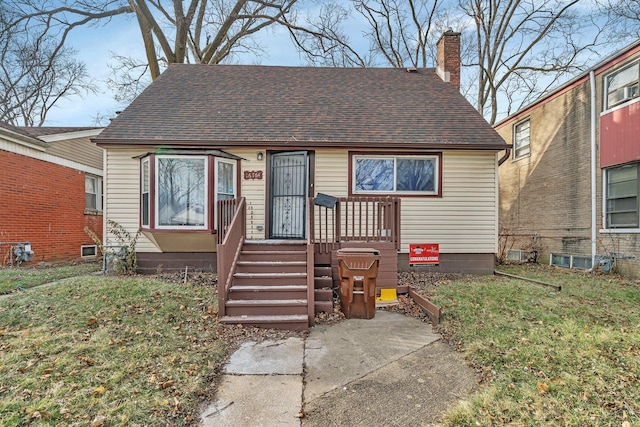 16764 Head Ave, Hazel Crest, IL 60429 - view of front of home with a front lawn, a shingled roof, and a chimney