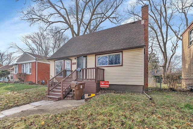 16764 Head Ave, Hazel Crest, IL 60429 - view of front of house with a chimney, fence, a shingled roof, and a front yard