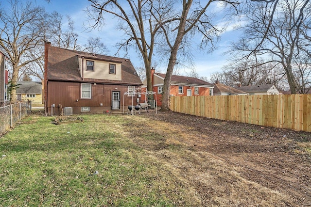 16764 Head Ave, Hazel Crest, IL 60429 - rear view of house with a chimney, a shingled roof, a fenced backyard, cooling unit, and a lawn