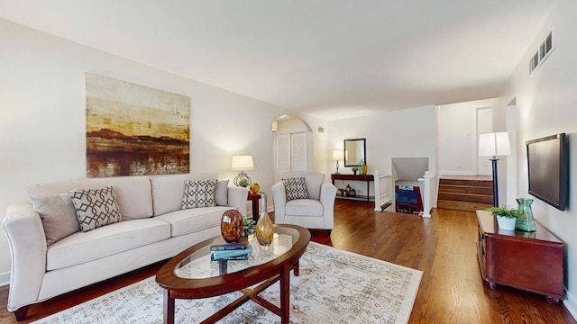 7350 N Karlov Ave, Lincolnwood, IL 60712 - living room with arched walkways, wood finished floors, and stairs