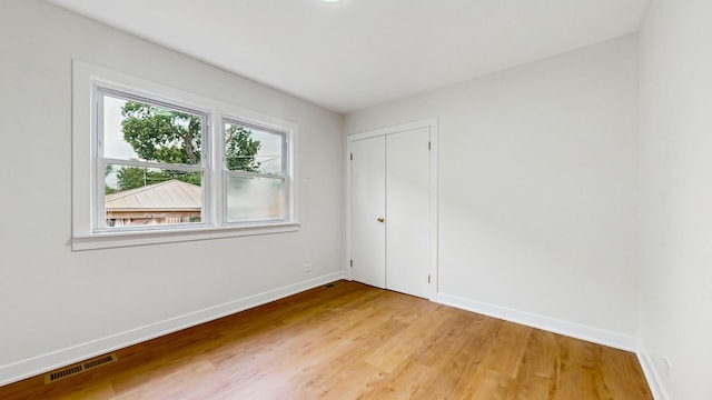 7350 N Karlov Ave, Lincolnwood, IL 60712 - unfurnished bedroom with light wood-type flooring and a closet