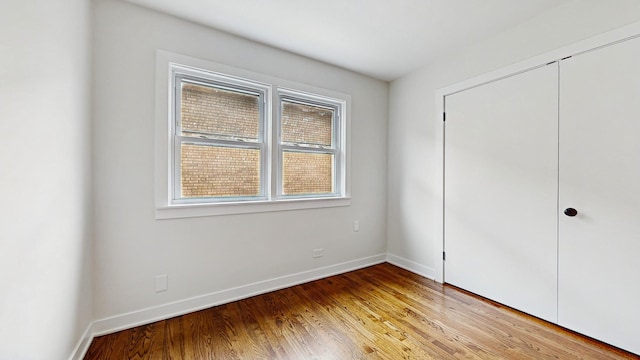 7350 N Karlov Ave, Lincolnwood, IL 60712 - unfurnished bedroom featuring light wood-style floors and a closet