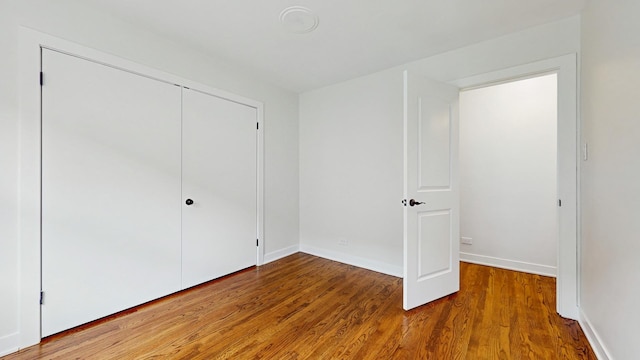 7350 N Karlov Ave, Lincolnwood, IL 60712 - unfurnished bedroom featuring wood finished floors and a closet