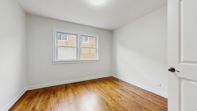 7350 N Karlov Ave, Lincolnwood, IL 60712 - spare room with wood finished floors and baseboards