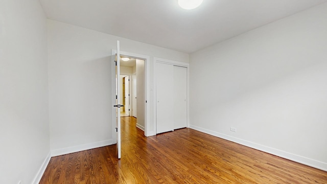 7350 N Karlov Ave, Lincolnwood, IL 60712 - unfurnished bedroom featuring wood finished floors and a closet