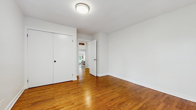 7350 N Karlov Ave, Lincolnwood, IL 60712 - unfurnished bedroom featuring wood finished floors and a closet