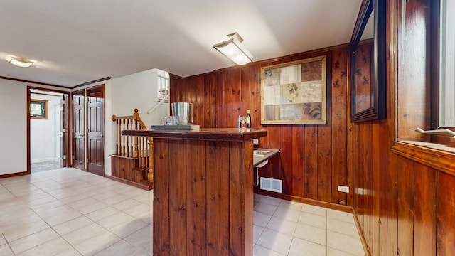 7350 N Karlov Ave, Lincolnwood, IL 60712 - indoor dry bar with wooden walls, light tile patterned flooring, and stairway