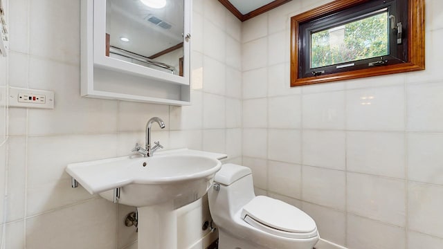 7350 N Karlov Ave, Lincolnwood, IL 60712 - half bathroom featuring tile walls and ornamental molding