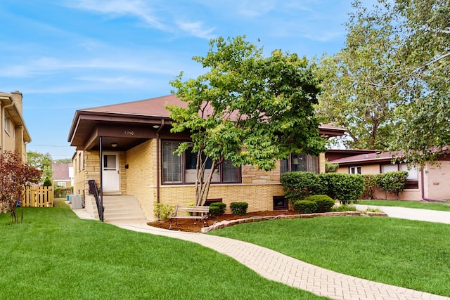 7350 N Karlov Ave, Lincolnwood, IL 60712 - view of front of house with a front yard and brick siding