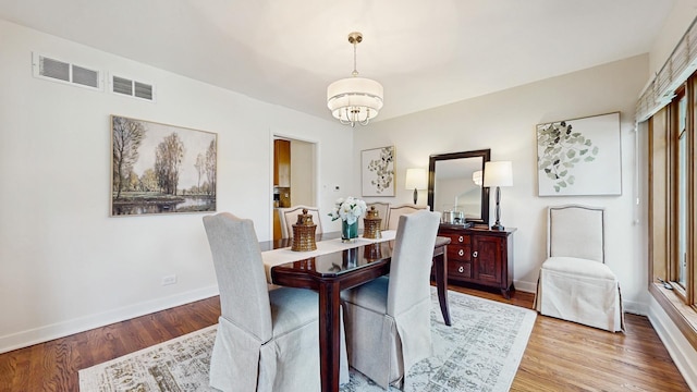 7350 N Karlov Ave, Lincolnwood, IL 60712 - dining space with wood finished floors and a chandelier