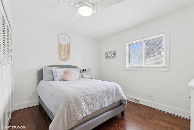 bedroom with visible vents, baseboards, ceiling fan, and wood finished floors