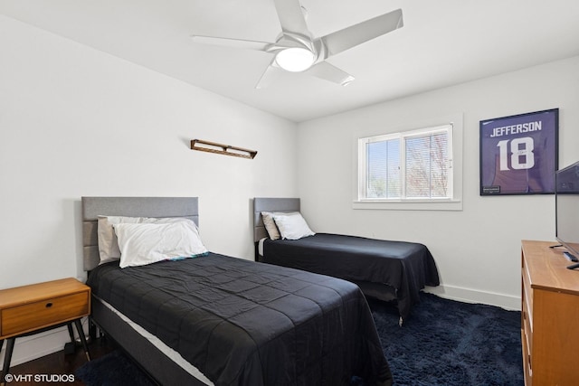 bedroom with baseboards, a ceiling fan, and dark colored carpet