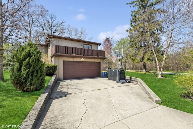 view of front of home featuring a garage, a front lawn, a balcony, board and batten siding, and concrete driveway