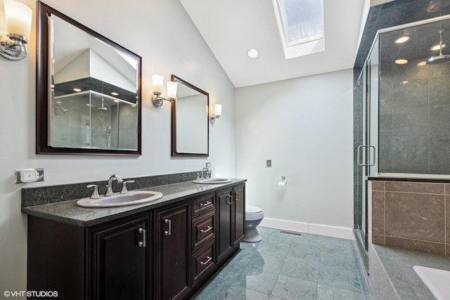 full bath with visible vents, a sink, a stall shower, and vaulted ceiling with skylight