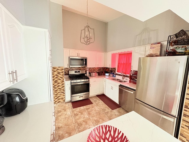 16117 Wabash Ave, South Holland, IL 60473 - kitchen featuring a sink, a chandelier, stainless steel appliances, light countertops, and white cabinets